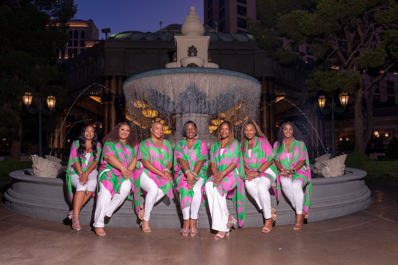 Sisters seated at the fountain at night