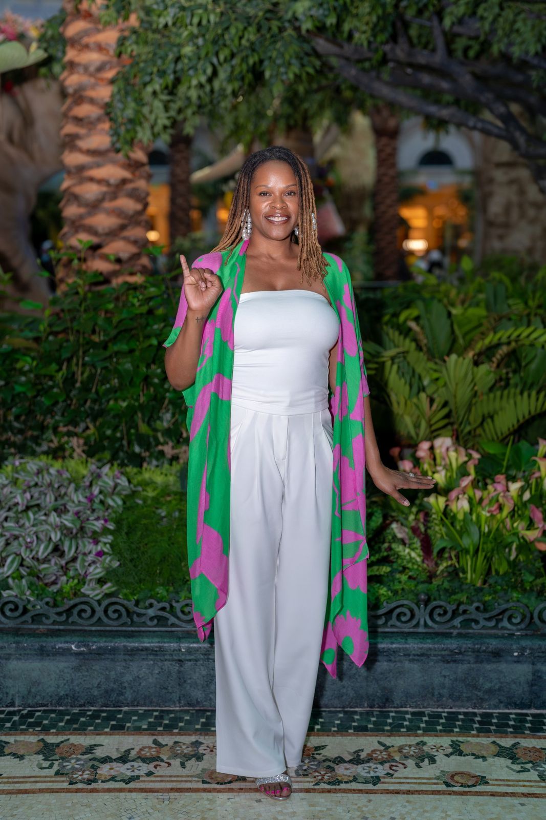 Portrait in pink and green duster, garden path
