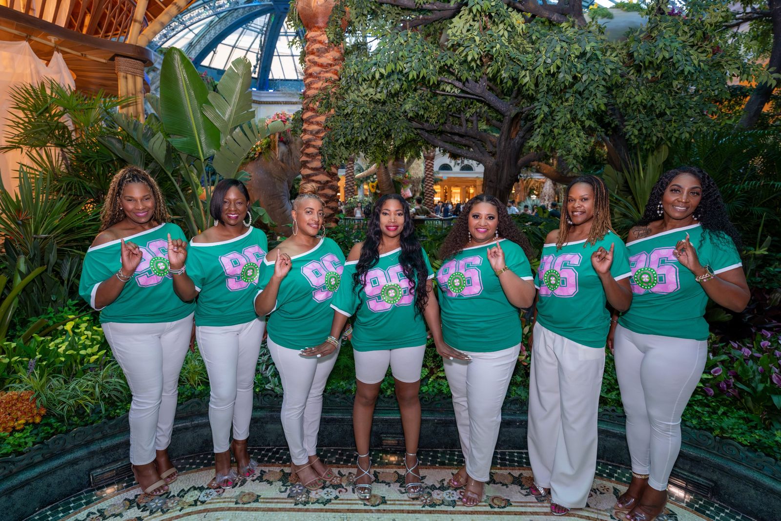 Group photo with pink and green letter shirts