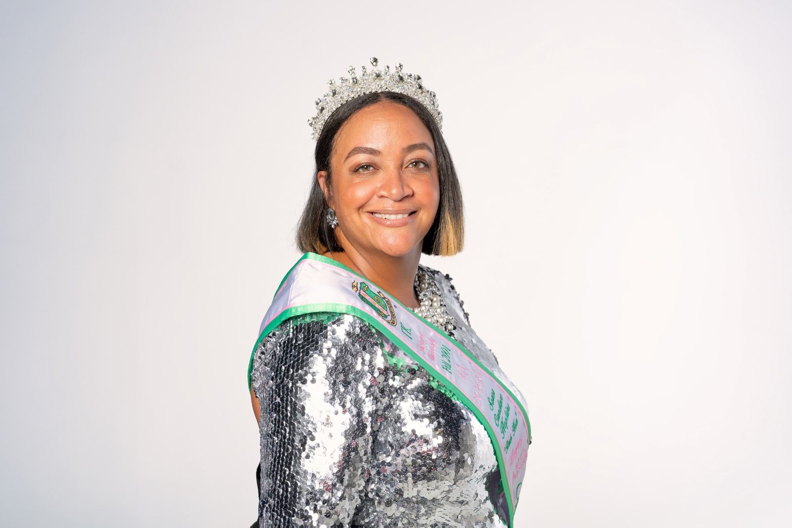Individual portrait with tiara, sash and pearls