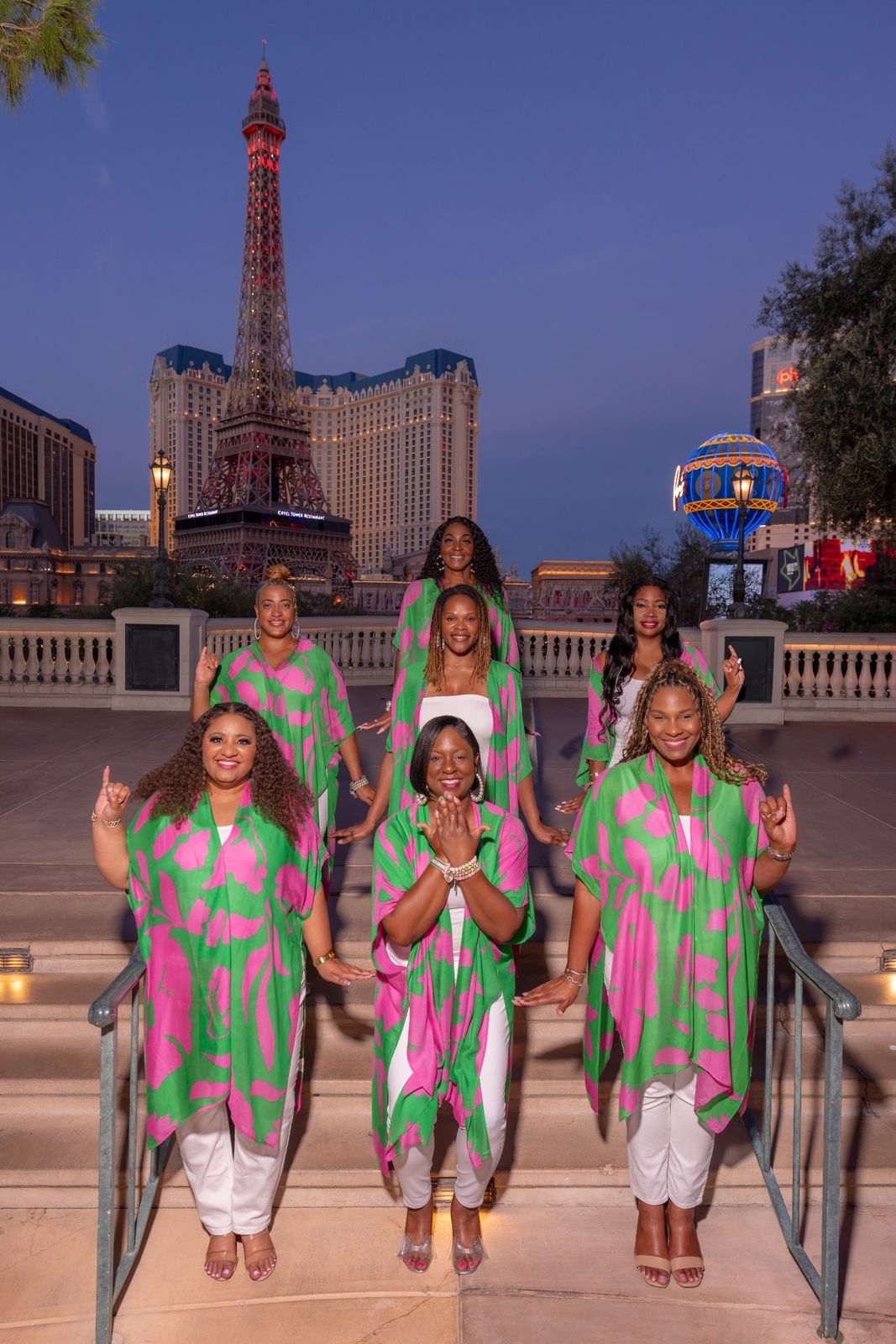 Group pose with the tower lit behind